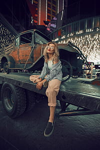 woman with gray jacket sitting on platform trailer thumbnail