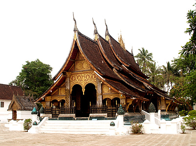brown wooden building surrounded with trees under white sky at daytime thumbnail