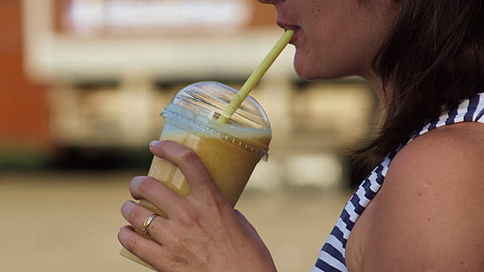 woman drinking beverage on disposable cup thumbnail
