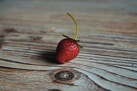 close-up photo of red strawberry on brown surface thumbnail