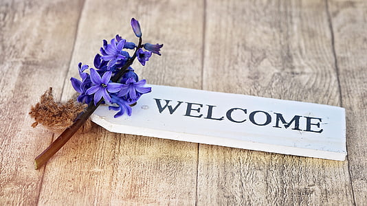 white wooden Welcome signage on brown wooden surface thumbnail