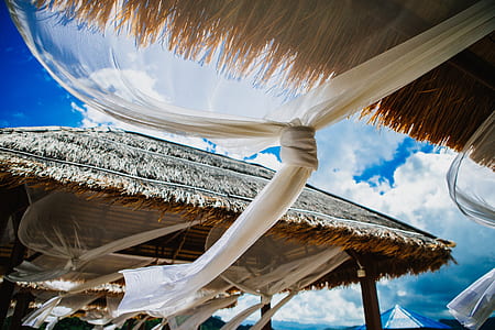 white tied curtain beside hut thumbnail