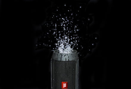 black JBL Charge 2 speaker with water splashing on top thumbnail
