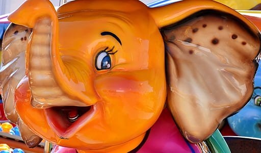 orange and red ceramic elephant figurine close-up photo thumbnail