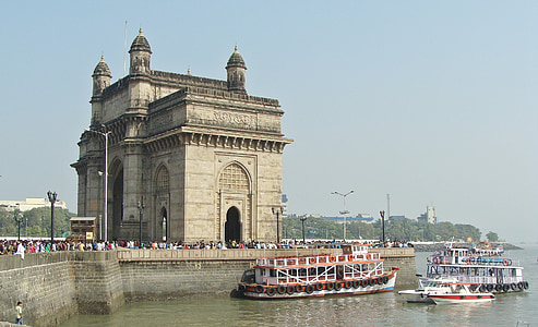 photography of two boats next to brown concrete building during daytime thumbnail