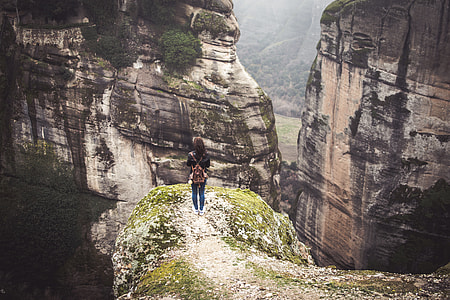 woman standing on top of mountain facing two rocky mountain thumbnail