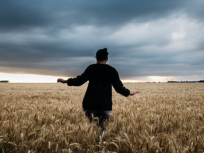 woman walking on grass field thumbnail