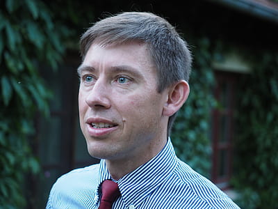 man wearing gray striped dress shirt and maroon necktie thumbnail