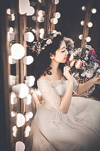 woman in white dress holding bouquet of flowers thumbnail