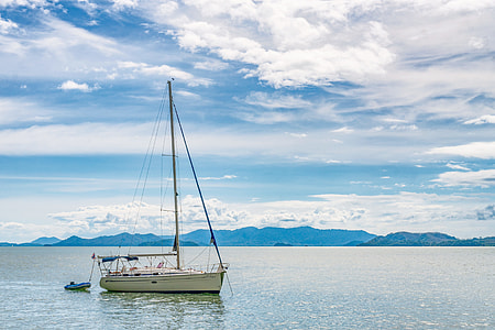 white boat floating on body of water thumbnail