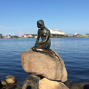 mermaid statue near body of water during daytime thumbnail