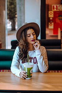 woman in white sweatshirt sitting on restaurant thumbnail