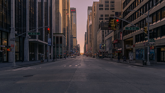 people walking on the side of the street with traffic lights thumbnail