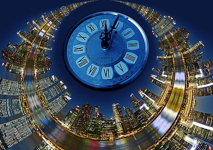 closeup photo of analog clock at 12:05 with high rise tower thumbnail