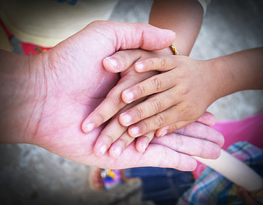 toddler's hand holding elder person's hand thumbnail