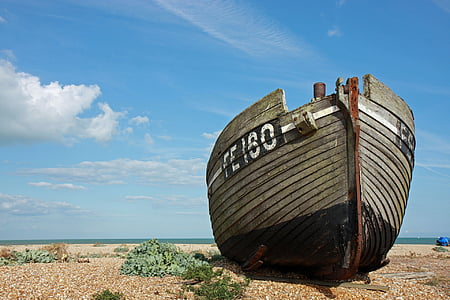 brown boat on seashore near body of water thumbnail