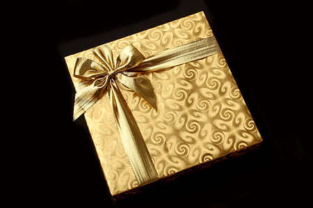 photo of yellow gift box on black background thumbnail