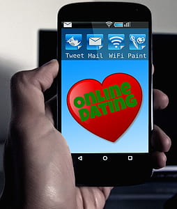 person holding phone displaying online dating template thumbnail