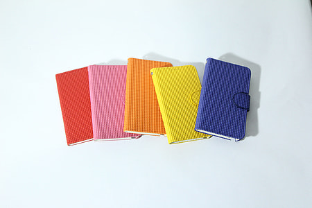 five assorted-color wallets on white surface thumbnail