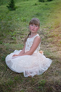girl wearing white dress sitting on grass thumbnail