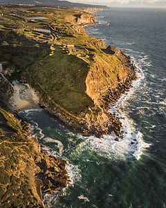 green island near body of water thumbnail
