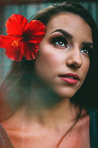 woman with red hibiscus flower on her hair thumbnail