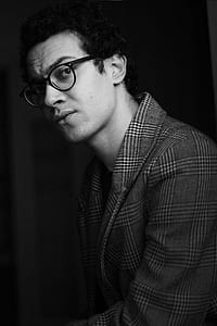 grayscale photography of man wearing eyeglasses thumbnail
