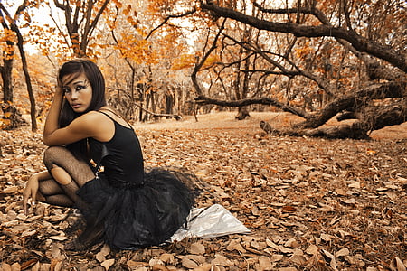 woman sitting on ground under forest thumbnail