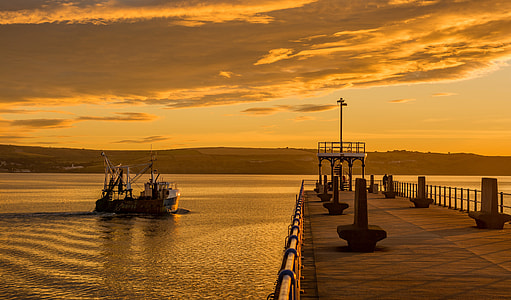 boat near dock during golden hour thumbnail
