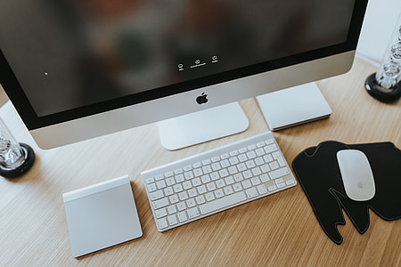 White Apple iMac computer with elephant mousepad thumbnail