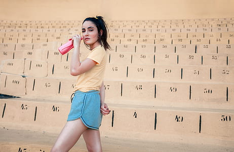 woman holding pink plastic tumbler thumbnail