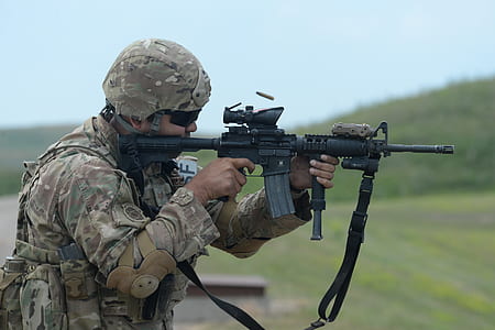 man holding black rifle while sighting thumbnail