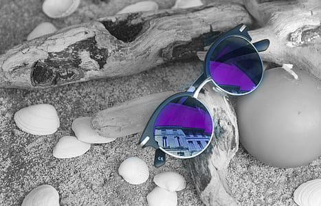 closeup photo of sunglasses on drift wood thumbnail