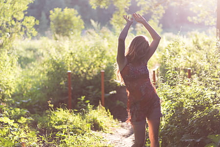 woman standing beside plants thumbnail