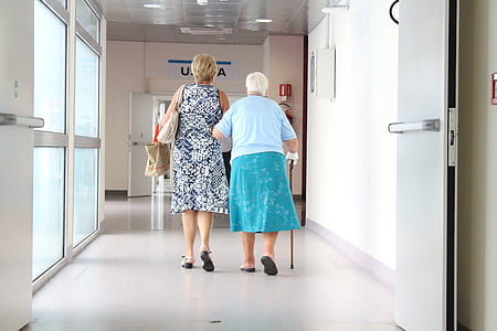 man in white and shirt and green skirt beside woman in white and gray dress thumbnail