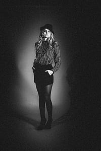 Grayscale Photo Of A Woman Wearing Black Cap thumbnail