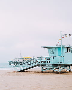 green life guard hut during day time thumbnail