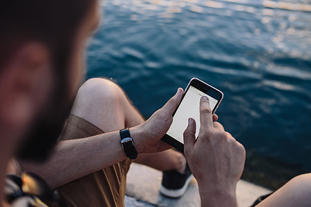 Mobile phone in man's hands near the sea thumbnail