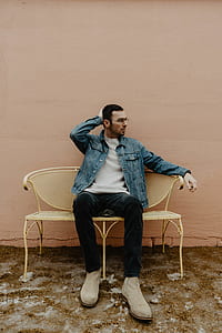 man sitting on beige metal mesh bench thumbnail