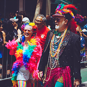 man wearing suit beside woman wearing multicolored dress thumbnail