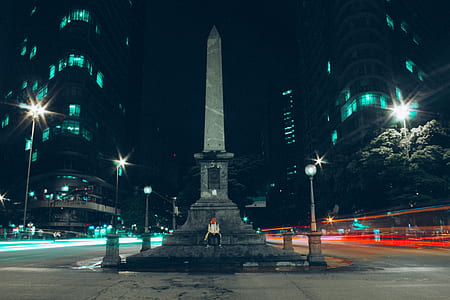 person standing near tower at nighttime thumbnail