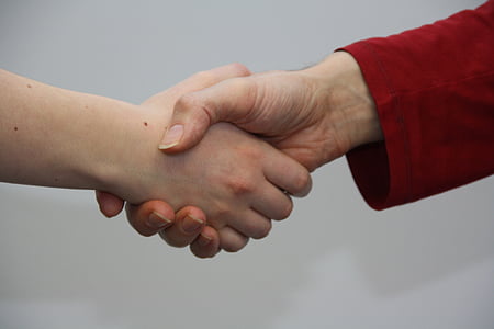 two people doing shake hands in focus photo thumbnail