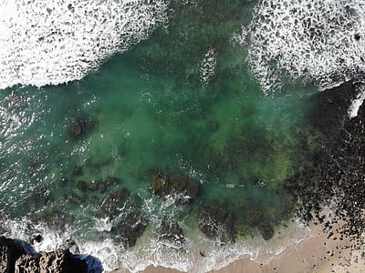 aerial photo of body of water and gray stones thumbnail