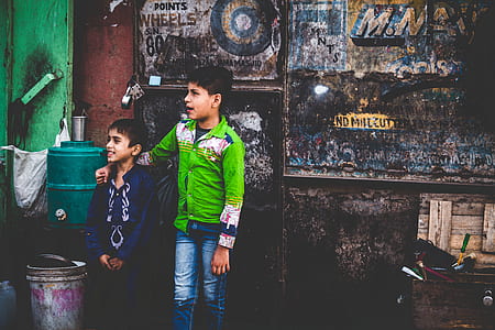 two boys standing near wall thumbnail