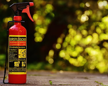 red and yellow metal sprayer in shallow focus shot thumbnail