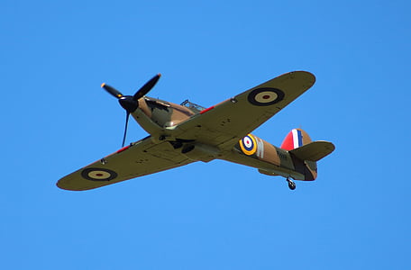 green propeller plane flying in mid air thumbnail
