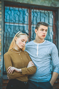man in gray sweatshirt and woman in brown button-up shirt thumbnail