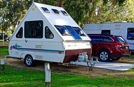 white and blue trailer beside red SUV at daytime thumbnail