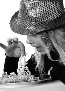 grayscale photography of woman eating pasta thumbnail