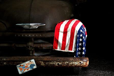 black Chevrolet vehicle with US flag on left headlight thumbnail
